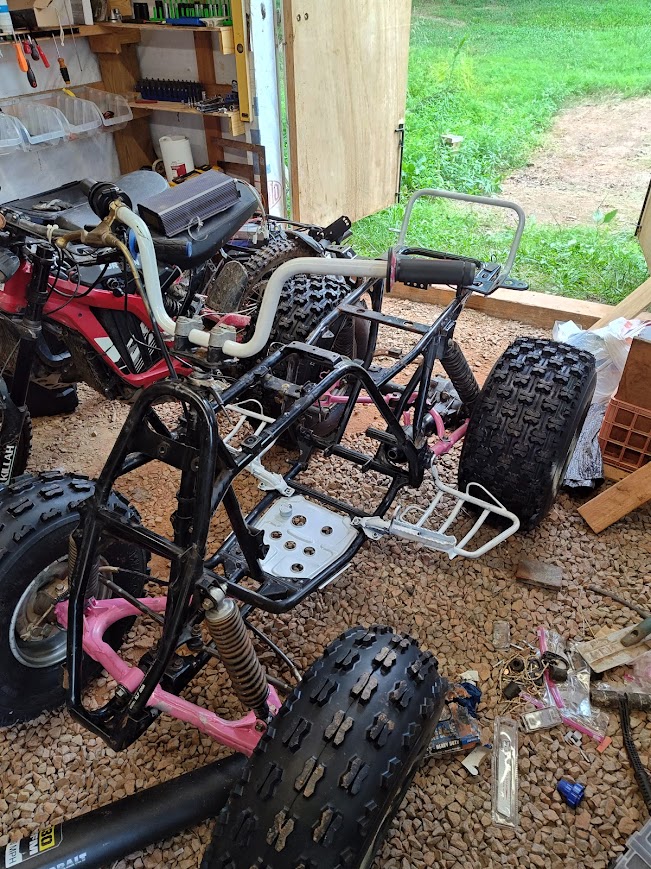 The ATV frame with pink painted suspension components
