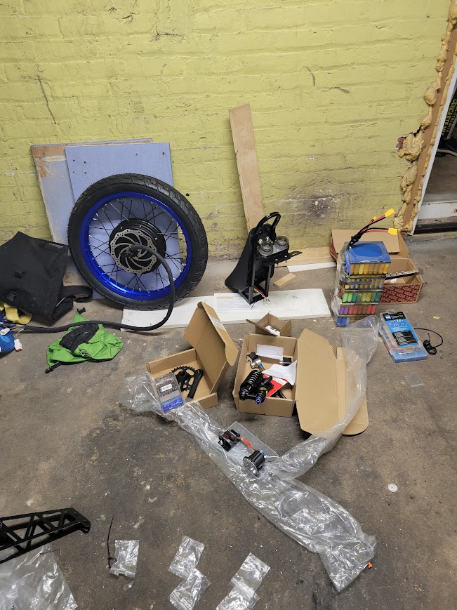 Various bike parts laid out on the floor